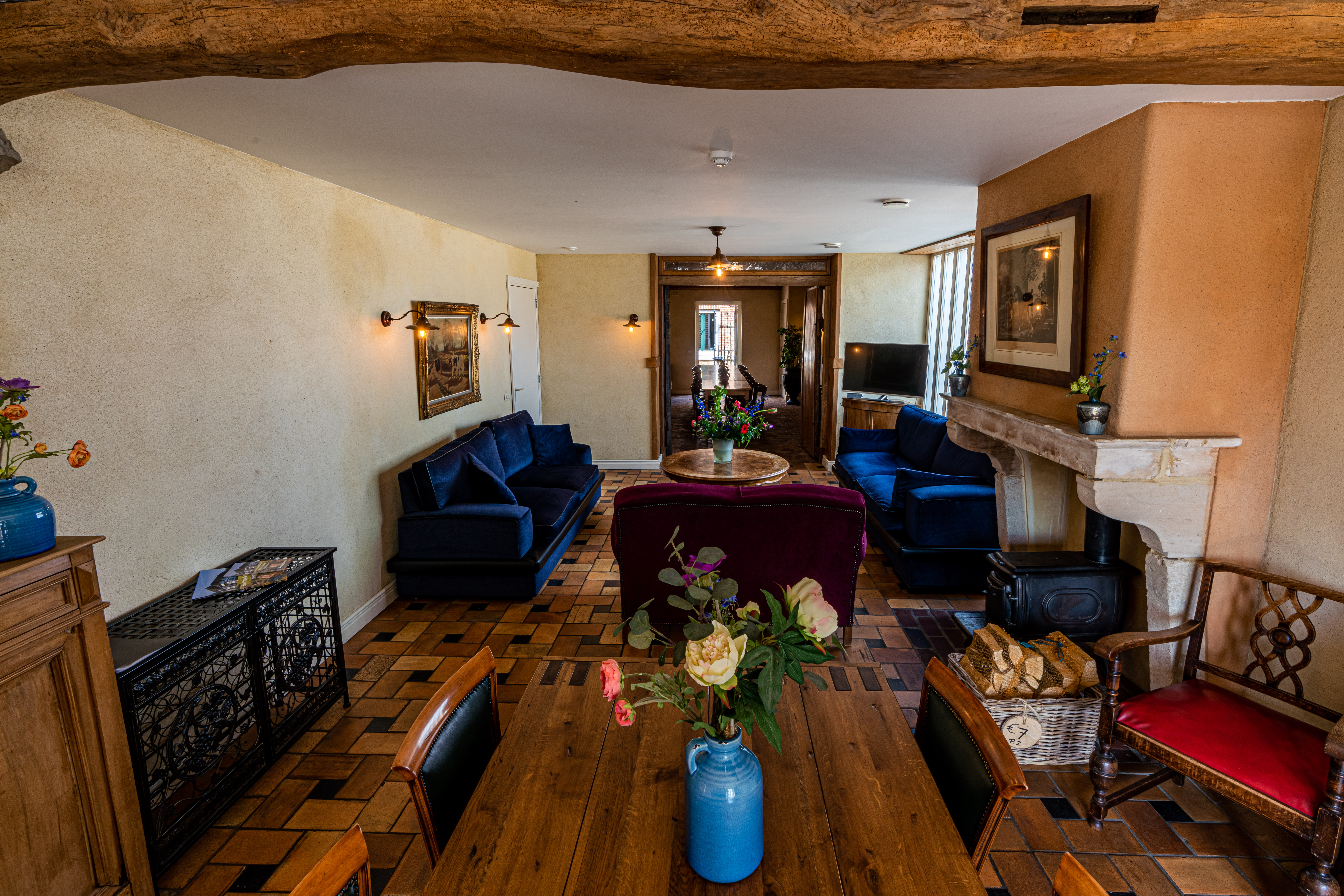 Spacious living room with open fireplace and wooden beams