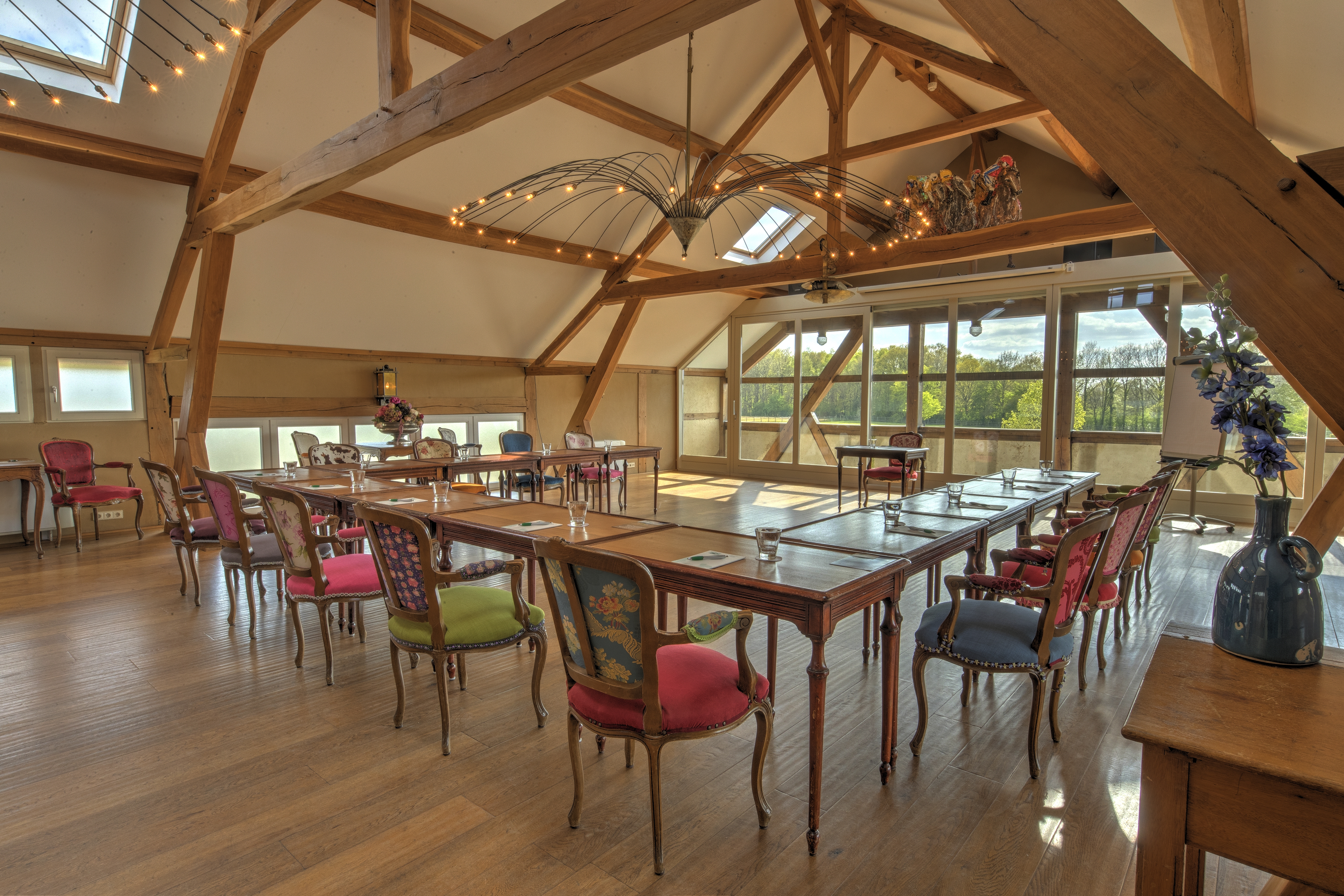 Rustic meeting room with wooden beams and U-shaped setup, suitable for an offsite meeting